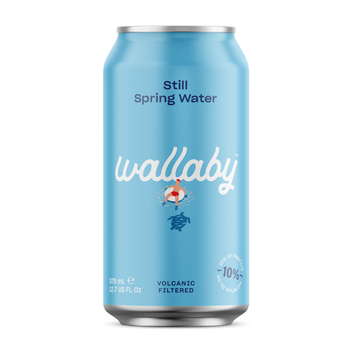 A light blue aluminum can of Wallaby Still Spring Water on a plain white background. The can features the brand name 'wallaby' in white script, a small illustration of a person in a red life jacket and blue life vest, and text indicating it is volcanic filtered and 10% less carbonated.